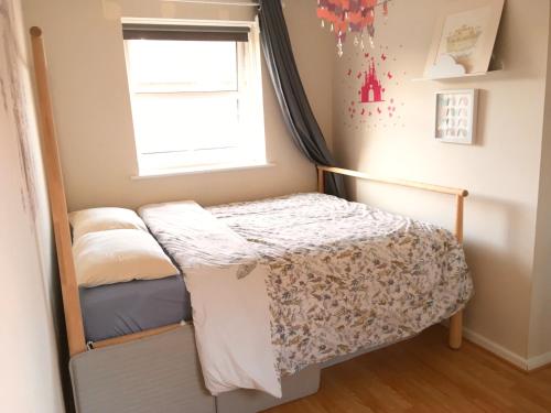 a small bedroom with a bunk bed and a window at Entire House in Christchurch in Christchurch