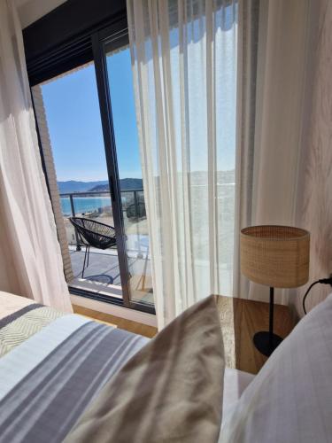 a bedroom with a bed and a view of the ocean at Casa Buena Vista con piscina y ascensor in Cullera