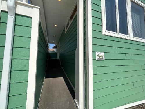 een gang van een huis met groene zijkanten bij Pier Harbor #1 in Saint Ignace