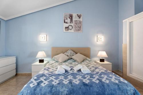 a blue bedroom with a bed with two lamps at Torviscas Alta Vista in Adeje