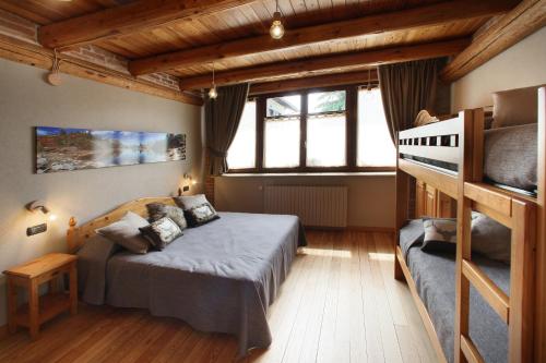a bedroom with a bed and a large window at Locanda Occitana Cà Bianca in Roccabruna