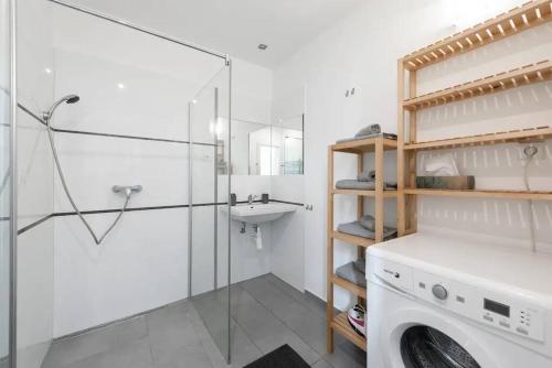 a bathroom with a washing machine and a sink at 2 bedrooms apt near Wenceslas sq in Prague