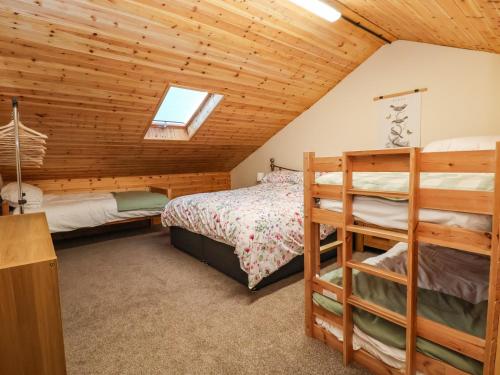 a bedroom with a bed and a bunk bed at The Old Nursery in Malpas
