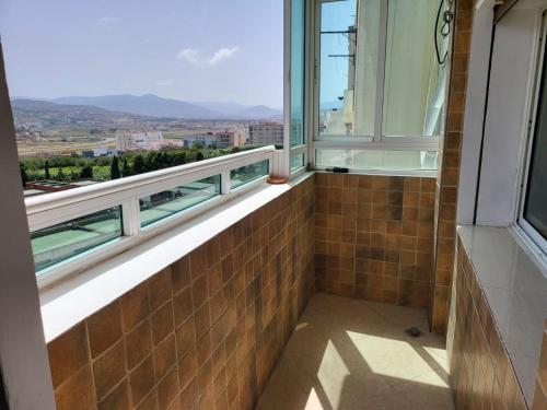 a room with a window with a view of a city at Vaste appartement au centre de Tetouan in Tétouan