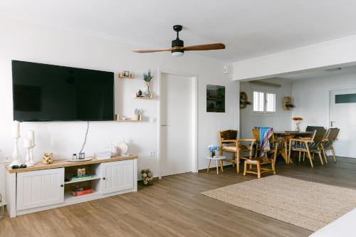 a living room with a flat screen tv on the wall at Rodini House in Kato Rodini