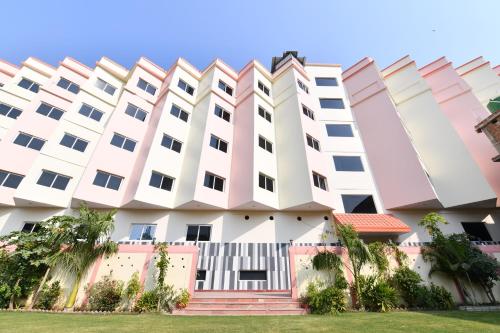 a building with white and pink at HOTEL ANAND INTERNATIONAL in Bodh Gaya