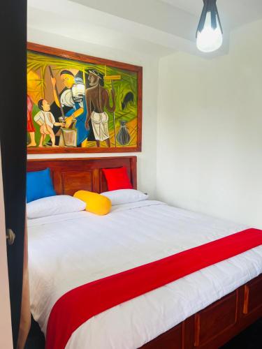 a bedroom with a bed with a painting on the wall at SKYRAH REACH in Kandy