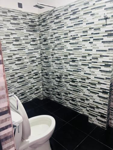 a bathroom with a white toilet and a sink at SKYRAH REACH in Kandy