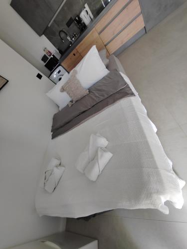 a large bed with white sheets and pillows at Mediterranean Vista in Dubrovnik