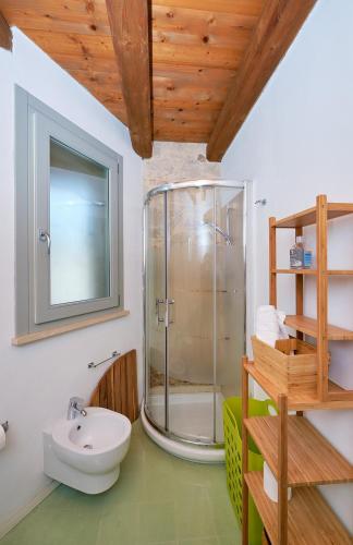 a bathroom with a shower and a toilet and a sink at Petrantica in Marina di Ragusa