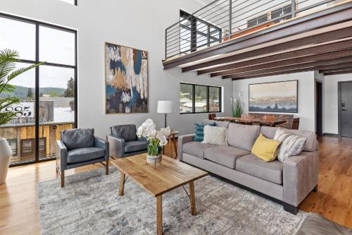 a living room with a couch and two chairs and a table at McGregor & Main - Luxury Lofts in Hill City