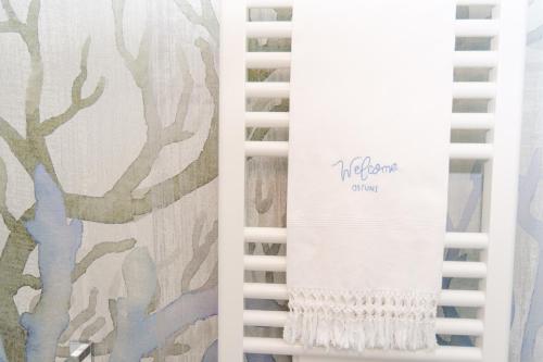 a white spiral notebook with a painting of trees at Welcome Ostuni b&b in Ostuni