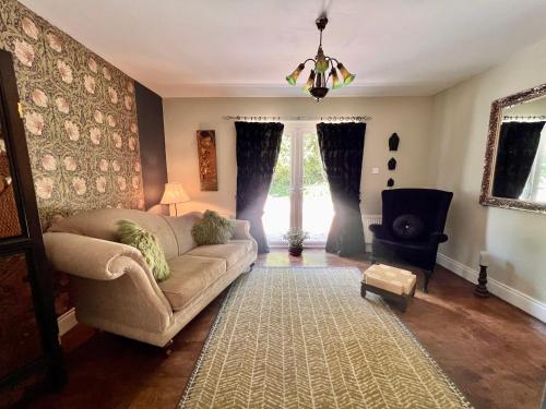 a living room with a couch and a window at LOCH CONNELL LODGE in Letterkenny