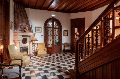 a living room with a staircase and a fireplace at Chalet Ficalho in Cascais