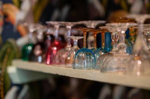 a row of wine glasses on a shelf at Chalet Ficalho in Cascais