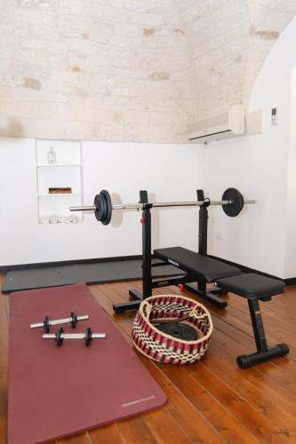 a gym with a bench and weights on the floor at Welcome Ostuni b&b in Ostuni