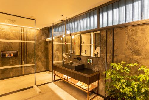 a bathroom with a sink and a glass wall at Beyond by Sula in Nashik