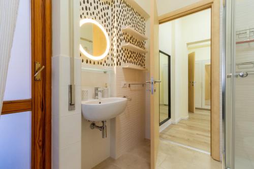 a bathroom with a sink and a mirror at Sonnino House in Cagliari
