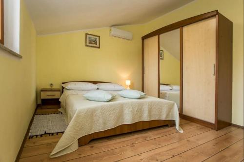 a bedroom with a bed and a large mirror at Apartment Petar in Begi in Vrsar