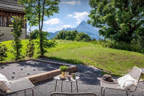 a patio with two chairs and a table with a view at Chalet Mevi - OVO Network in Crest-Voland