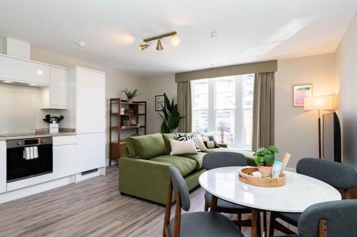 a living room with a couch and a table at Wellington Place I Your Apartment in Bristol