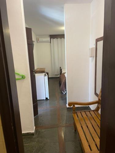 a hallway with a wooden bench in a room at Pousada Minas Goiás in Tiradentes