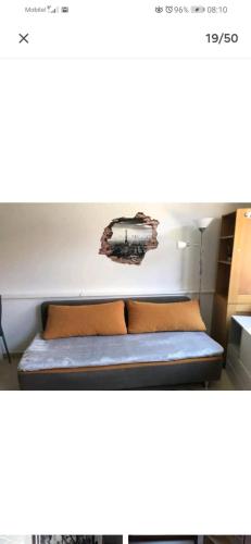 a bed with two pillows and a sign on a wall at COSY APARTMENT FILIP IN THE HISTORICAL OLD TOWN in Koper