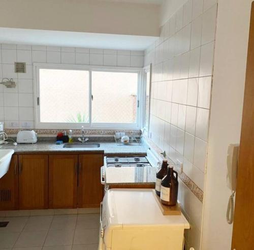 a kitchen with a stove and a sink and a window at Live & Work Apart in Buenos Aires city, near park! in Buenos Aires