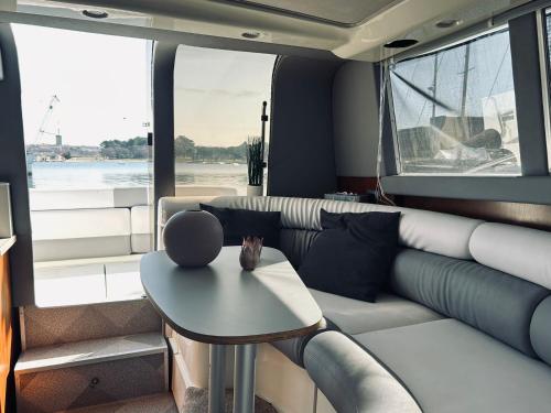 a living room with a couch and a table at Dream Night Boats in Poreč