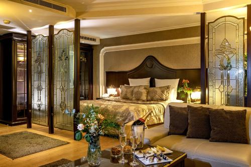 a hotel room with a bed and a couch at Altinel Ankara Hotel & Convention Center in Ankara