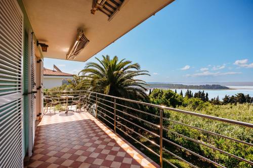 a balcony with a view of the water at Old Road Rooms and Apartments with Pool in Portorož