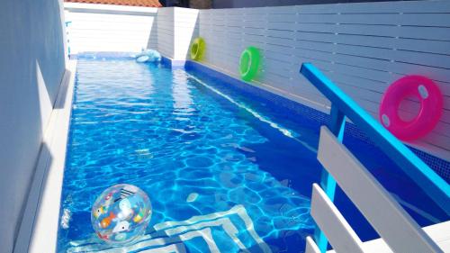 a swimming pool with a ball in the water at Ibiscus and Lily Apartments in Rhodes Town