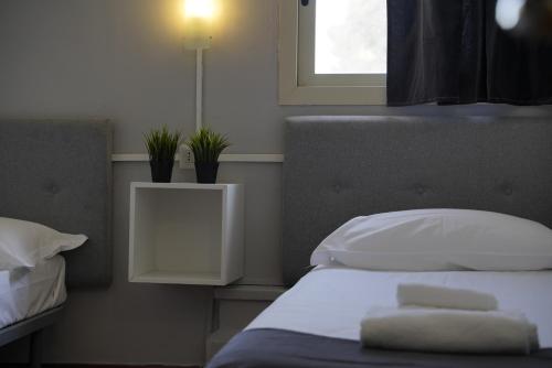 a bedroom with a bed with white pillows and a window at Airport suite in Catania