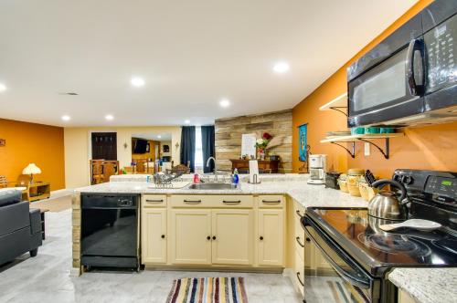a kitchen with yellow walls and a stove top oven at Charming Virginia Getaway Near Hiking and Golfing! in Lynchburg