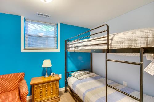 a bedroom with two bunk beds and a chair at Charming Virginia Getaway Near Hiking and Golfing! in Lynchburg