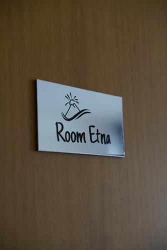 a sign on a door that reads room emiratio at Airport suite in Catania