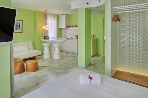 a bathroom with a sink and a toilet in a room at Tropicana Ibiza Suites - Adults Only in Playa d'en Bossa