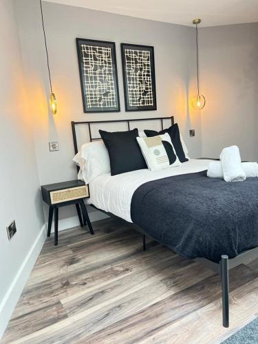 a bedroom with a large bed with black and white pillows at Modern spacious Belfast city stay free parking in Belfast