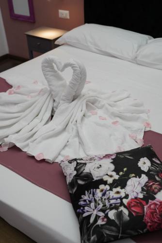a blanket on top of a bed with a towel at Airport suite in Catania