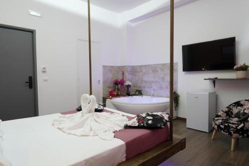 a bedroom with a bed with a tub and a sink at Airport suite in Catania