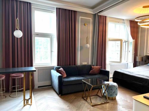 a living room with a couch and a table at Studio apartment in the center of Riga in Riga