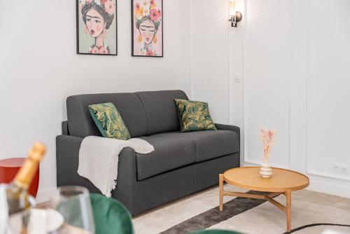 a living room with a couch and a table at 2mn Monaco - Luxueux appartement rénové - AS in Beausoleil