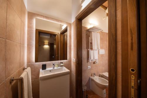 a bathroom with a sink and a mirror at BORGO A MONTI di Sotto in Gaiole in Chianti