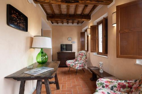 a living room with a couch and a table and chairs at BORGO A MONTI di Sotto in Gaiole in Chianti