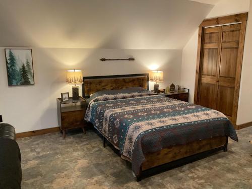 ein Schlafzimmer mit einem Bett mit zwei Nachttischen und zwei Lampen in der Unterkunft MOJO'S LOFT 