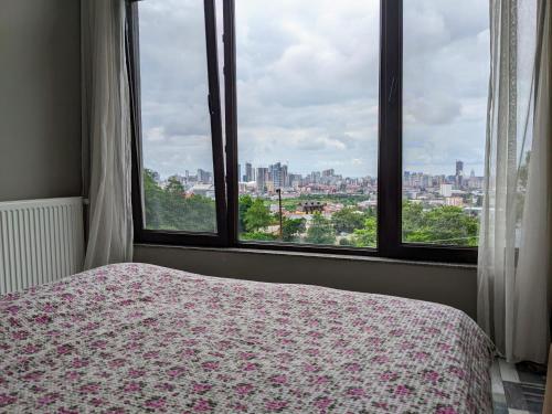 a bedroom with a bed and a view of a city at Гостевой дом с красивой панорамой на город in Batumi
