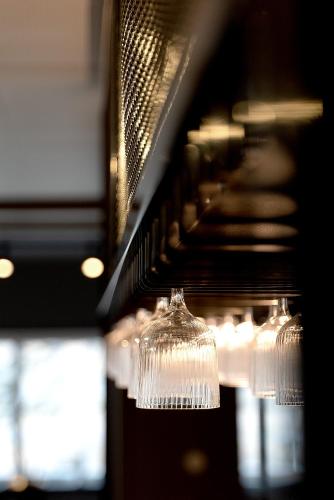 a row of wine glasses hanging from a rack at Hotel Montagne in Åmmeberg