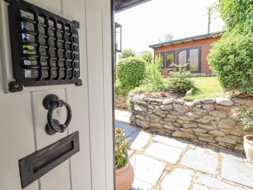 a door to a house with a stone wall at Neuadd Wen in Derwen