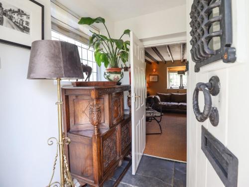 a living room with a lamp and a hallway at Neuadd Wen in Derwen