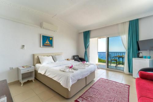 a bedroom with a bed with a view of the ocean at Likya Inn in Karadere